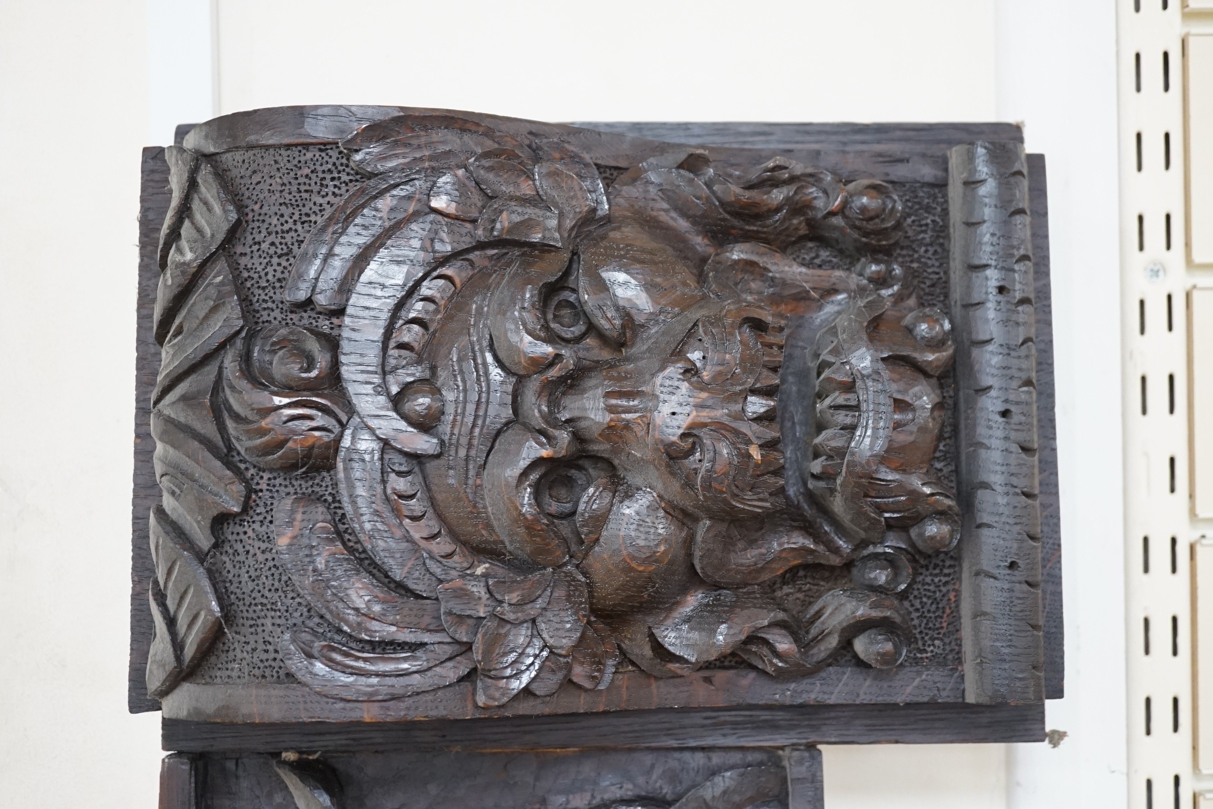 Seven assorted carved wooden panels, widest 166 cms